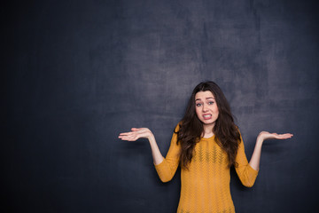 Young woman shrugging shoulders