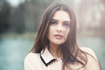 Naklejka premium Brunette Girl in Morning Sunlight Outdoors