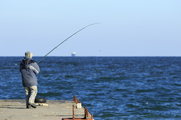 Fisher at the pier