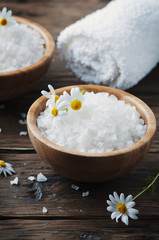 Fototapeta na wymiar Concept of spa treatment with salt and daisy