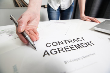 Business woman handing over a contract for signature offering