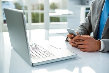 close up view of a businessman using his phone