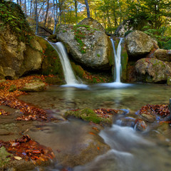 Landscape with autumn waterfall in the mountains