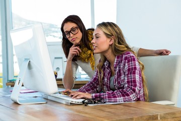 Two girls work at office