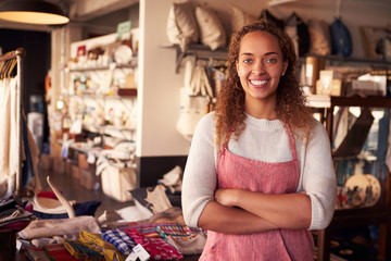 Fototapeta premium Portrait Of Female Owner Standing In Gift Store