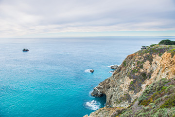 Benches facing the coastline in route 1 California , USA