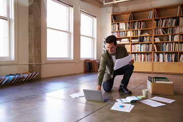 Businessman Laying Documents On Floor To Plan Project