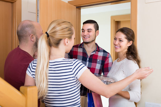 Happy Guests In Doorway