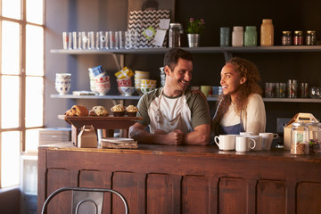 Couple Running Coffee Shop Standing Behind Counter