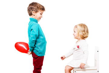 Boy  giving a red balloon to the girl 
