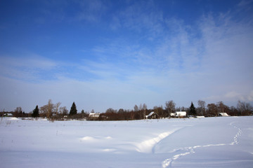 Winter snow rural landscape blue sky wooden houses in field