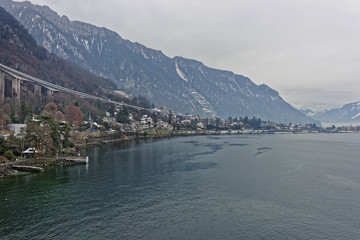 Fototapeta na wymiar Long bridge above Montreux and Lake Geneva in winter