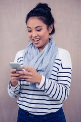 Surprised Asian woman using smartphone
