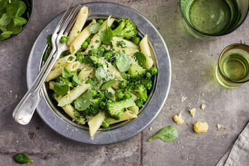 penne  pasta with spinach pesto sauce, green peas and broccoli