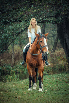 romantic sensual girl  on a horse in the forest