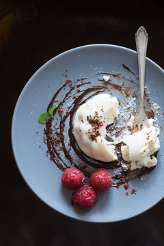 Vanilla panna cotta with chocolate sauce and fresh raspberries. Selective focus.