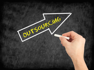 Outsourcing - hand writing text on chalkboard