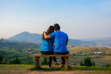 Naklejka na ściany i meble Scene of romantic and happy young romantic couple sitting with natural background.Love concept.