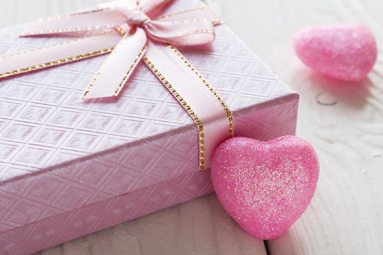 pink gift box with a heart closeup on white background