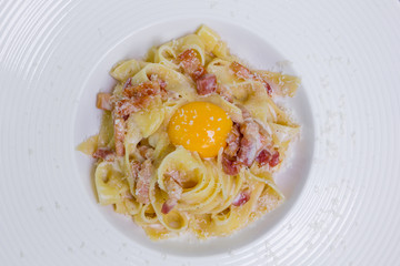 pasta carbonara with parmesan, egg yolk and bacon