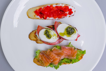 Italian bruschetta set (mini sandwich) with tomato, mozzarella and salmon