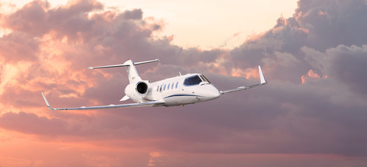 Frontal view of a private jet flying - obrazy, fototapety, plakaty