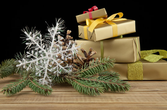 branch of fir-tree and gifts to Christmas