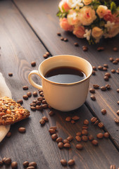 white cup of strong morning coffee on a brown table