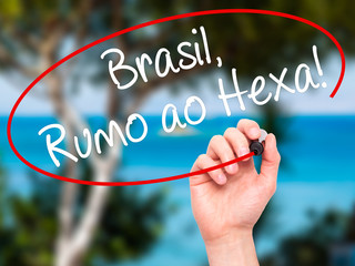 Man Hand writing Brasil, Rumo ao Hexa! with black marker on visu