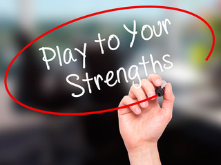 Man Hand writing Play to Your Strengths with black marker on vis