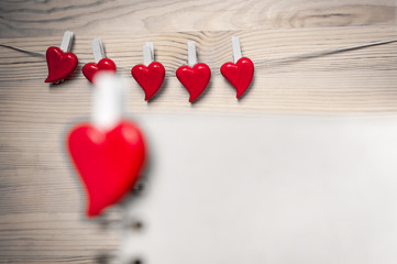 Red hearts on wooden background. Back focus.