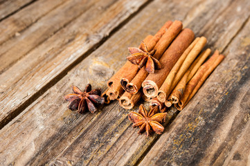 Cinnamon and anise on wooden background