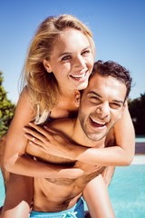 Boyfriend giving piggy back to his girlfriend