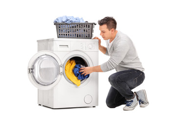 Man putting clothes in a washing machine