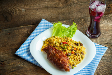 Dishes from turkey meat with rice and salad leaves and a glass o