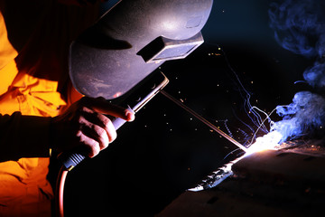 Close-up of welder working in workshop.