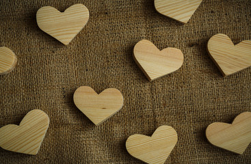 Wooden hearts on sackcloth background
