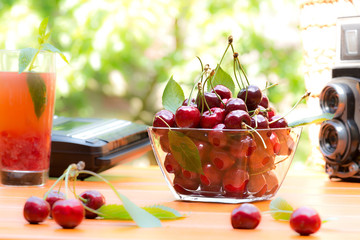 nostalgic still life with red cherry and old camera