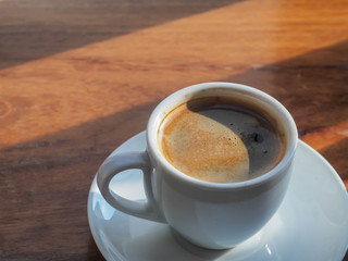 hot coffee and sunshine, blur wooden background