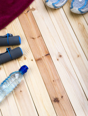 Sport Equipment. Sport Shoes, Dumbbells, Towel And Bottle Of Water On Wooden Boards.