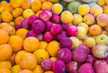 Oranges, apples and peaches for sale at a market