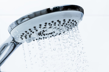 Naklejka na ściany i meble Clear water flowing from shower.