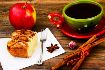 Apple Pie with Tea Cup on Woody Background.