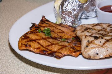chiken with pork chop on plate