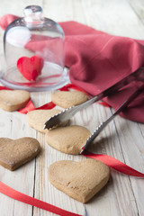 Fototapeta na wymiar Homemade Heart Shape Cookies With Red Ribbon