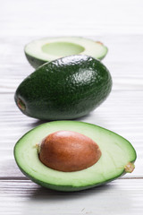 food background with fresh organic avocado on old wooden table