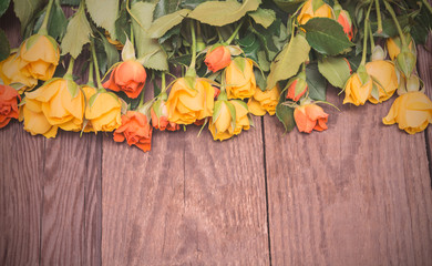 Yellow and orange roses on a wooden background. Women' s day, Va