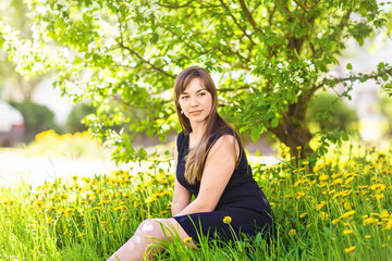 Naklejka na ściany i meble Beautiful young woman over white blossom tree, outdoors portrait