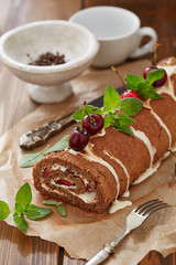 Swiss cake roll with cream and cherries