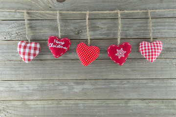 Hanging hearts christmas decorations wood background